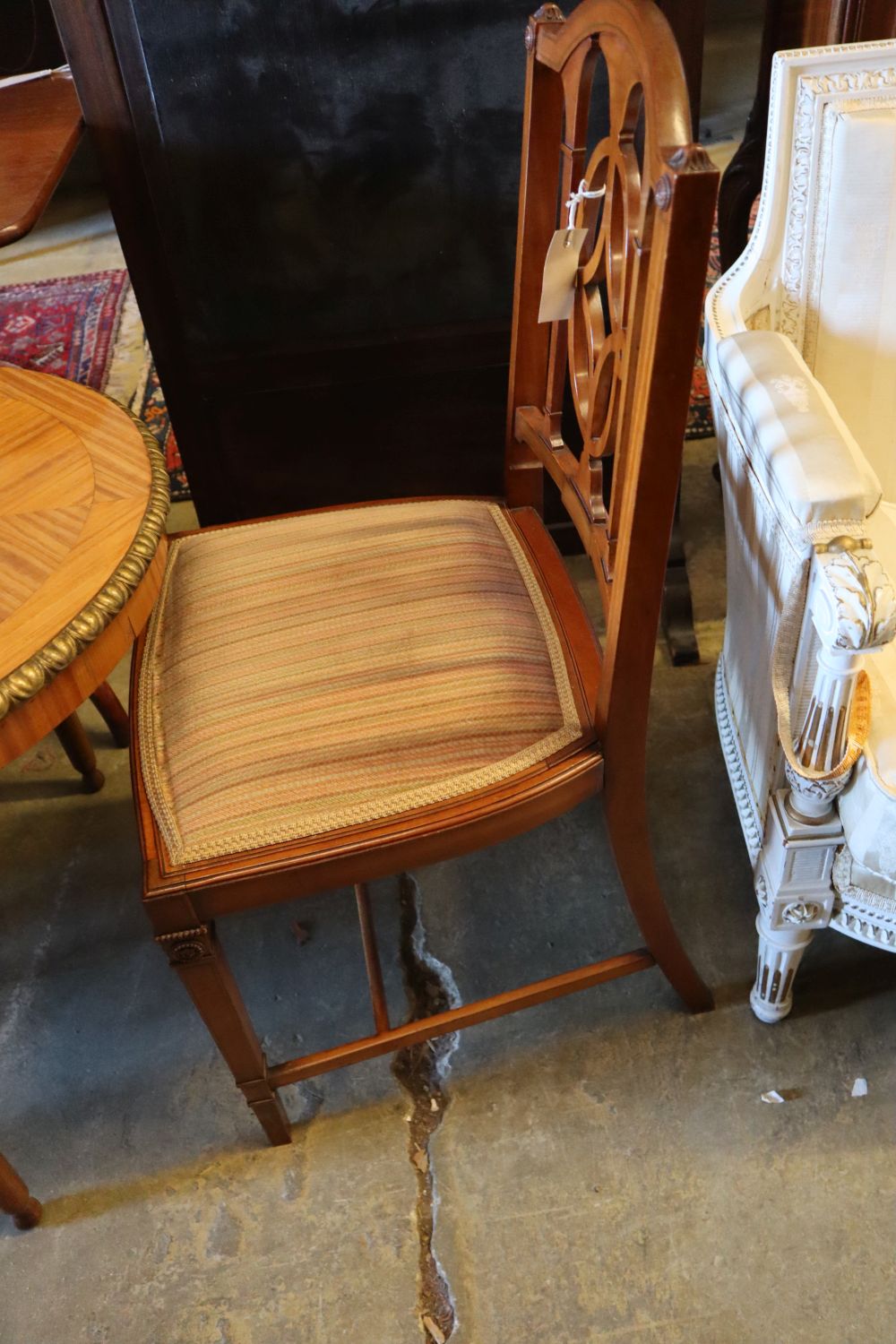 A parcel gilt satinwood centre table, width 113cm height 62cm, and a pair of Edwardian satinwood salon chairs